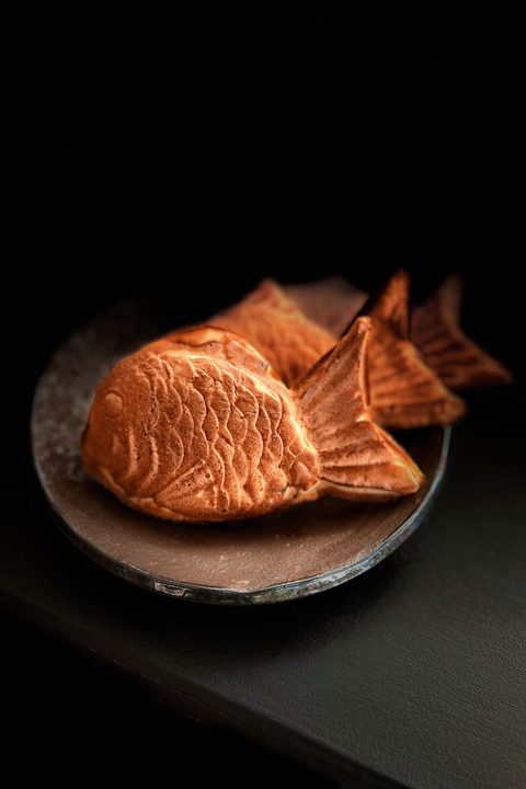 Golden taiyaki on a dark plate